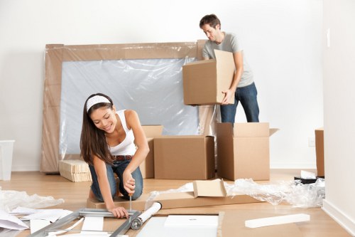 Preparing household items and boxes for collection by a man with van